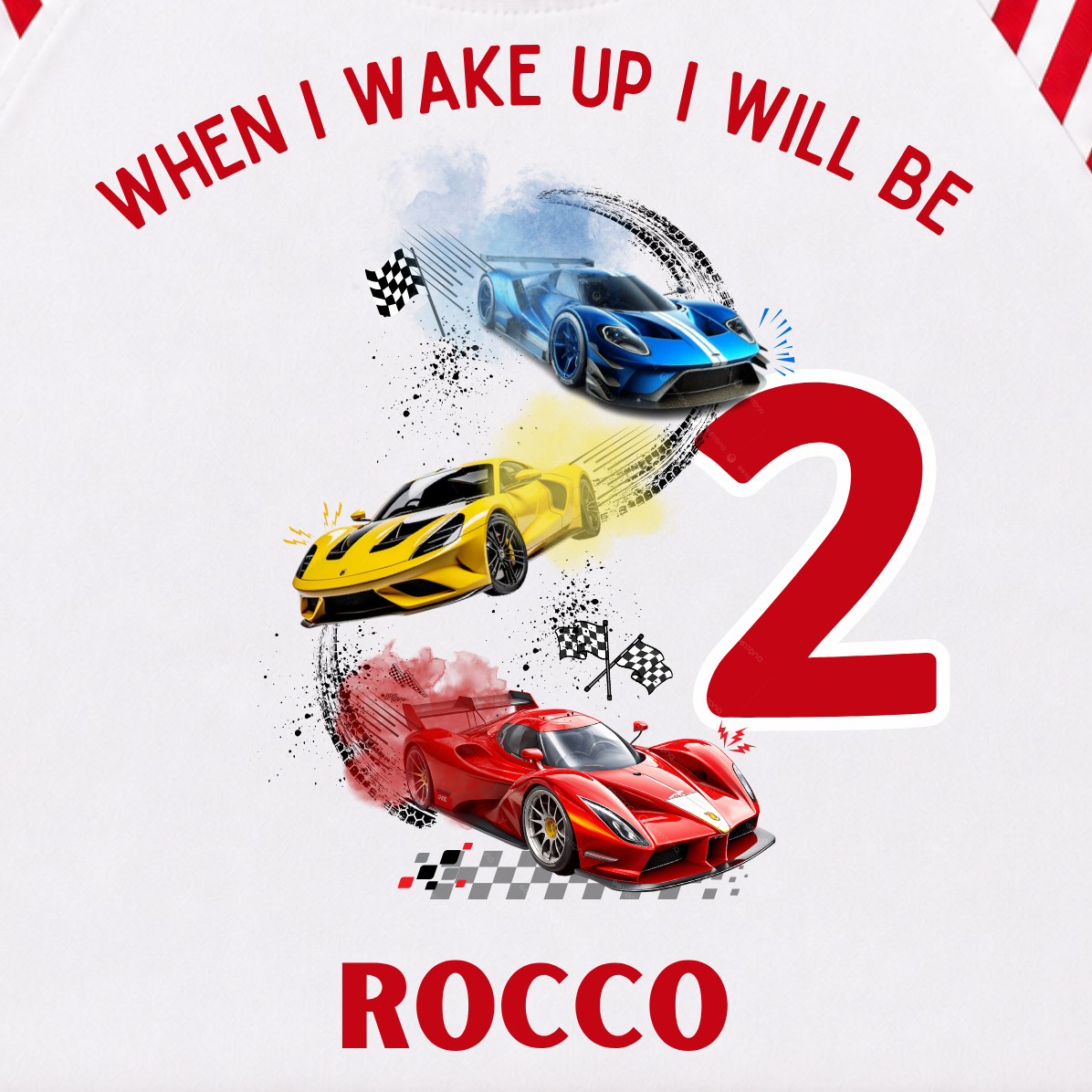 A children's two-piece pajama set laid flat on a light cream background. The long-sleeve top is white with red raglan sleeves and collar, featuring a colorful race car graphic and the text 'WHEN I WAKE UP I WILL BE 2 ROCCO'.